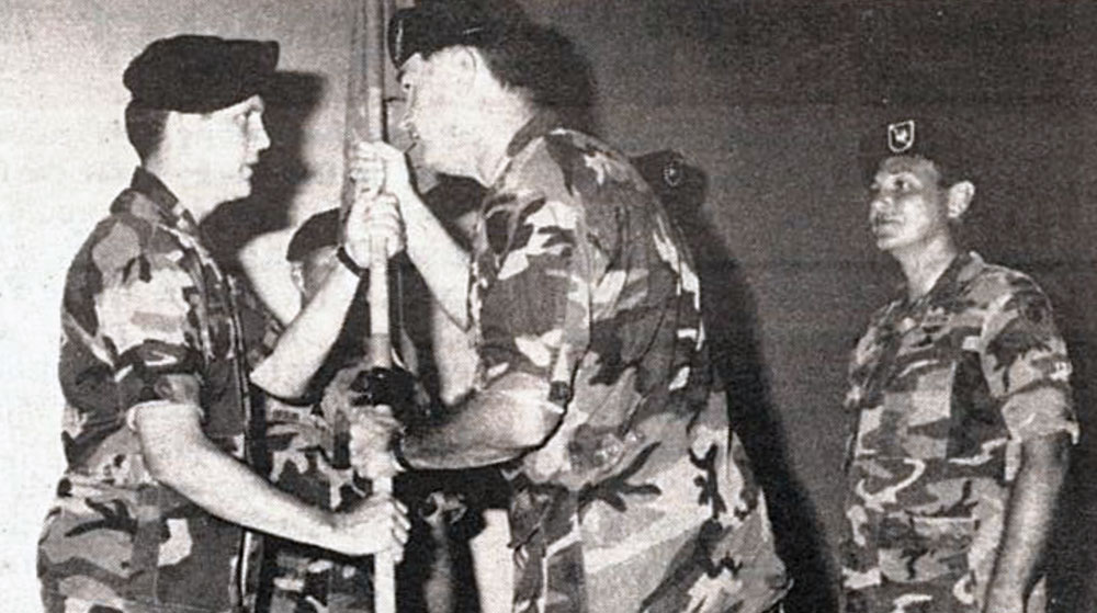 Colonel John N. Dailey accepts the 617th guidon from Major (MAJ) Kenneth J. Himmerlick, and prepares to pass it to the new company commander, MAJ Richard D. Compton, in July 1989.