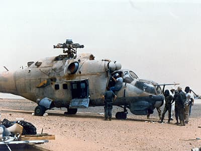 U.S. personnel prepare the Hind for sling-load. The Russian helicopter was already prepared and rigged by the time the 160th Chinooks arrived.