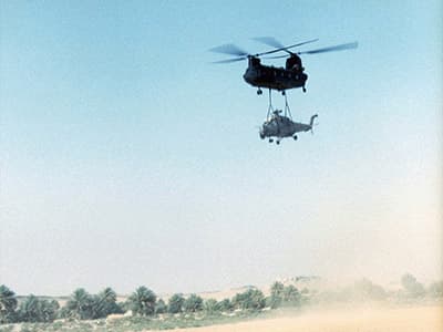 The Chinook and the sling-loaded Hind come into the Forward Arming and Refueling Point (FARP) at Faya Largeau, the first of two refueling stops.