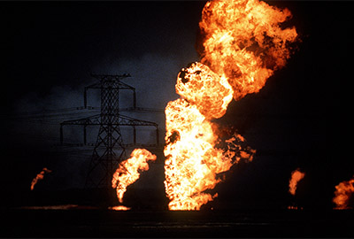 Retreating Iraqi troops set fire to Kuwaiti oil wells, severely limiting visibility and causing it to literally rain oil.