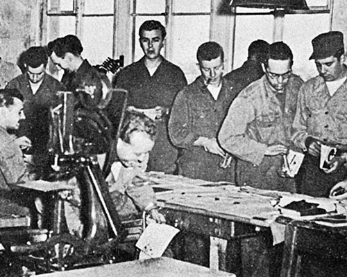 Enlisted soldiers from the Publication Platoon assemble leaflet books for COMBINE.