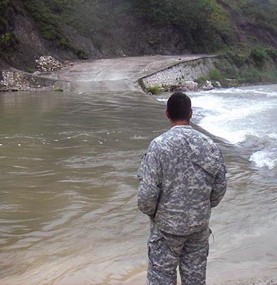 CPT Cider evaluates a river crossing site.