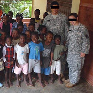 One of the numerous orphanages CAT 812 visited in and around Jérémie. CPT Cider (left) stands with SFC Michaels (right).