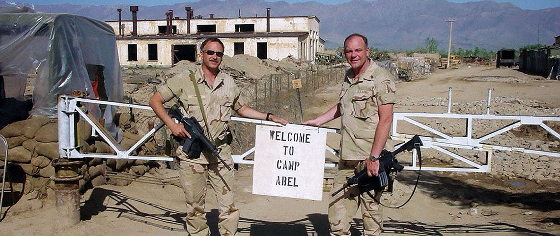 SGM Richard C. Kimmich nd CSM Christopher W. Abel at the access gate of Camp Abel