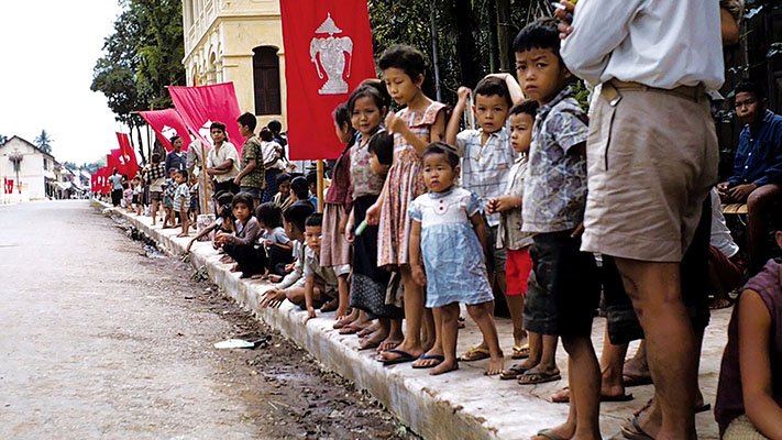 With Laotian flags prominently displayed, thousands lined the route to observe the funeral procession of King Sisavang Vong.