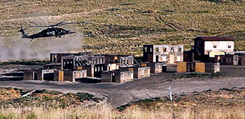 An MH-60 Blackhawk with part of the combined assault element lands in a mock town during VAJRA PRAHAR at Yakima Training Center on 10 August.  ODA 1412 planned the Advanced Military Operations in Urban Terrain (AMOUT) training.