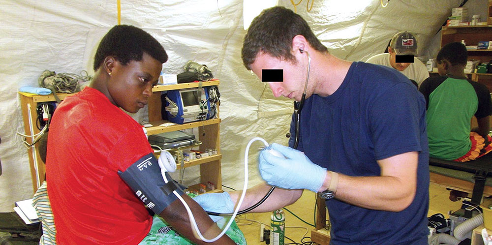 SGT Zane P. Anderson* examines an African woman