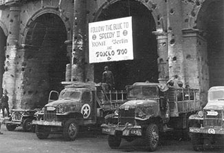 Soldiers of II Corps put up a sign on the side of the Coliseum in Rome.