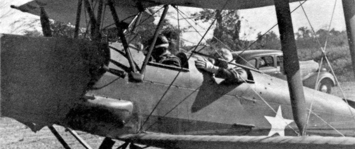 The de Havilland Gypsy Moth in which Lieutenant Colonel Eifler flew General Donovan behind Japanese lines to visit the KNOTHEAD group. In the rear and at the controls of the airplane is Lieutenant Colonel Carl Eifler, commanding officer of Detachment 101. General William J. Donovan is in the front seat.