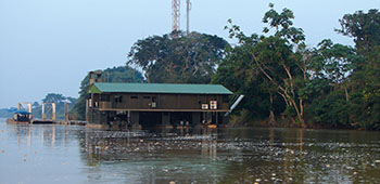 View from the bow of the boat as the Colombian medical volunteers and the Civil Affairs soldiers near Solano on the Caquetá River. The barge is a barracks ship and operations center for Colombian riverine forces operating against narco-terrorist organizations.