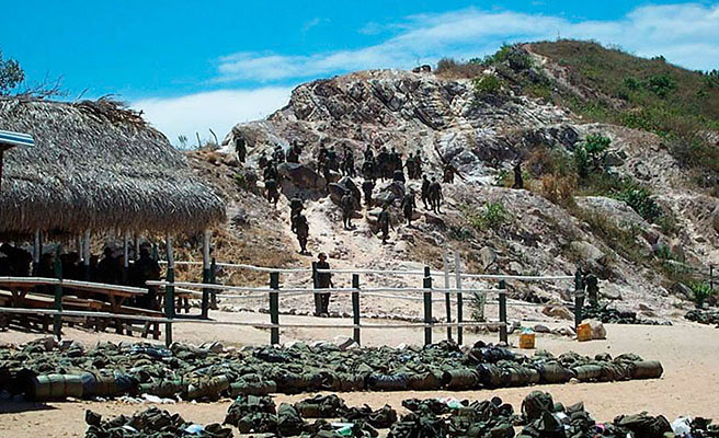 Carabineros moving up to the bare, rocky plateau that serves as their bivouac site.