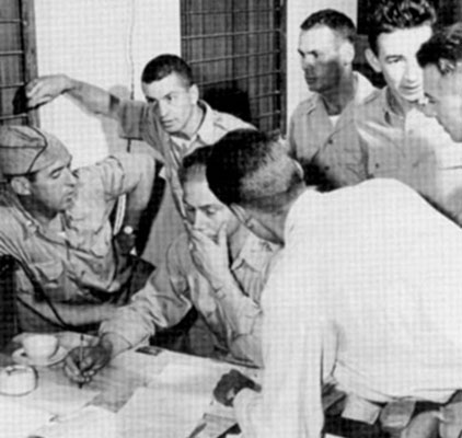 Detachment 404 officers planning an air drop operation into Thailand.