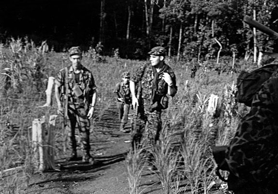 Sergeants Burhl Cunningham (left) and Lowell Stevens (right) on patrol with one of the CIDG companies.