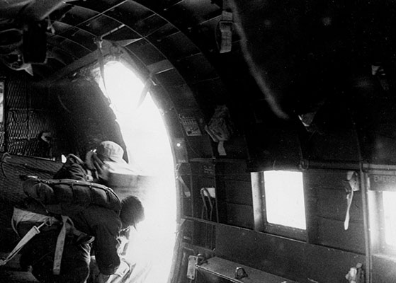 “Door kickers” preparing leaflets for airdrop.