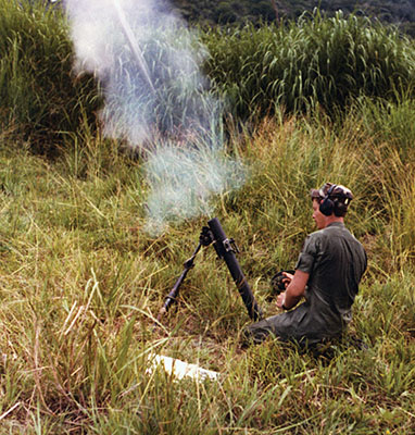 Staff Sergeant Gary Davidson fires the 60mm mortar during the ODA-7 “Gun-a-Rama” at Empire Range in Panama.