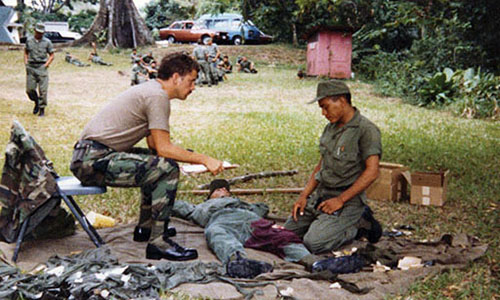 Sergeant Kenneth Beko, junior medic for ODA-7, explains emergency medical treatment to a Salvadoran soldier at Fort Sherman, Panama.