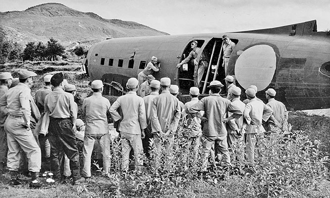 Chinese Commandos receive instruction on how to jump from a C-47 drop aircraft.