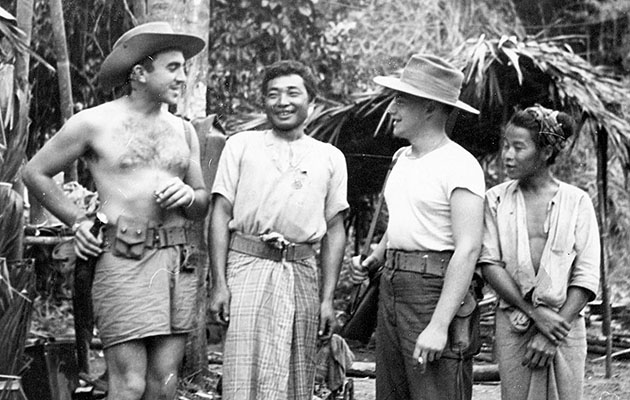 CPT Zachariah Ebaugh (left) jokes with indigenous troops.