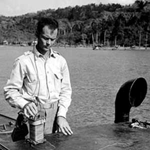 First Lieutenant Milton Beckwith of the Alamo Scouts demonstrates a waterproof radio  developed for use during infiltration of the  Pacific islands in Luzon, 1945. The Alamo Scouts collected critical intelligence on the Japanese for the 6th Army.