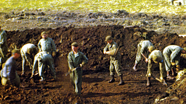 In order to pitch their Bell tents in the tundra, the Forcemen rolled back the muskeg and dug down to the volcanic bedrock. They drove their tent pegs into the rock to hold the tents up in the nearly continuous heavy winds.