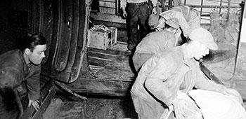 6. Detachment 101 personnel load cargo into a C-47 Skytrain.