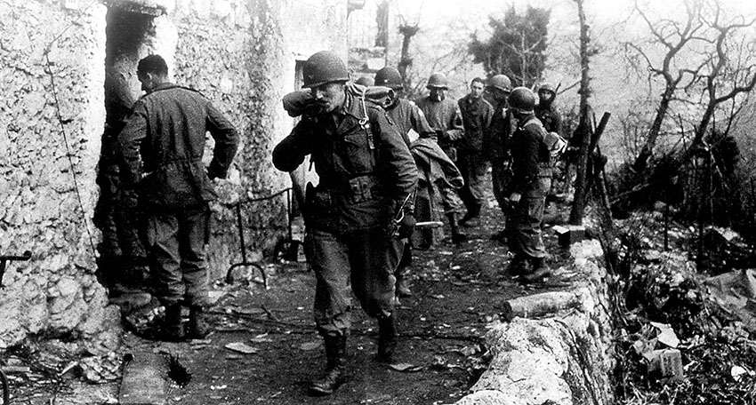 Colonel Robert T. Frederick leads the FSSF command section out of the village of Radicosa. Controlling operations in the mountains was difficult because mountain fighting was often conducted by squads and sections acting independently.