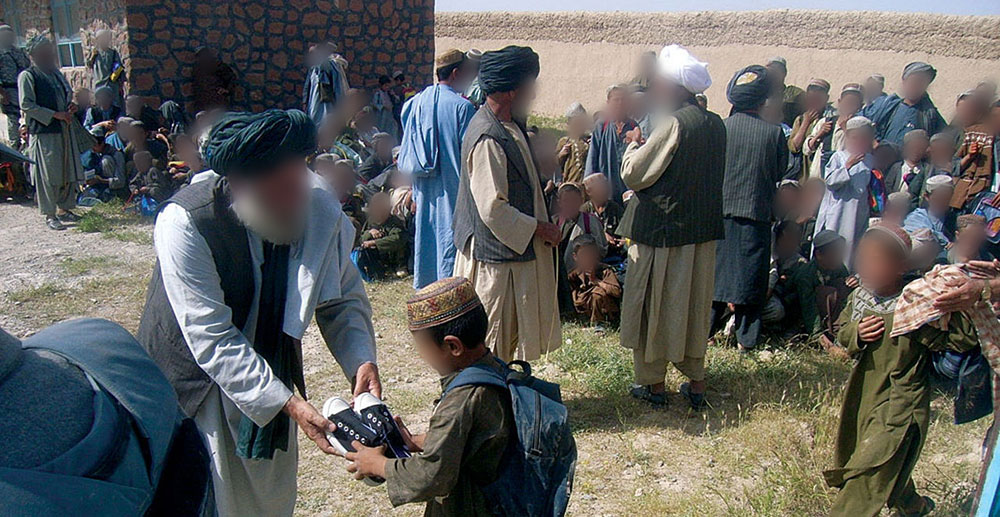 Village elders and government officials distribute new shoes. The ARSOF teams in Deh Rawod worked to improve living conditions in the area and to enhance the legitimacy of the local government.