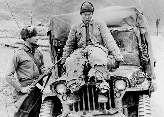 The large-scale intervention of Chinese Communist Forces, such as this one guarded by a soldier of the 3rd Ranger Company, surprised American combat commanders.