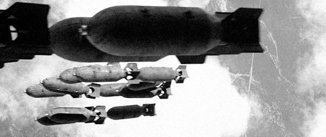 Rolled leaflets are loaded into 500 pound M16A1/2 Cluster Adapter Bombs.