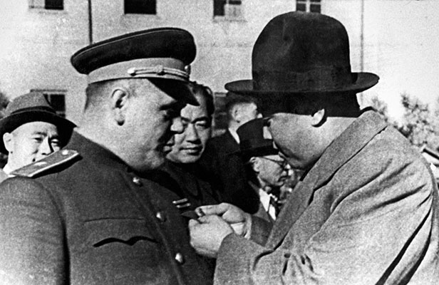 Soviet-North Korean military cooperation - Kim Il Sung pins a decoration on Soviet General Nikolai G. Lebedev, P’yongyang, North Korea, 1948.