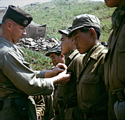 CPT Joseph Ulatoski pins wings on a recent guerrilla airborne graduate, 1952.