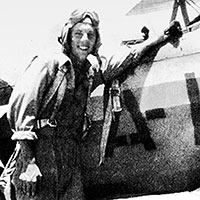 Aviation Cadet Harry E. Ettinger stands beside his Boeing Stearman N2S at the Naval Air Station in Corpus Christi, Texas, April 1946.