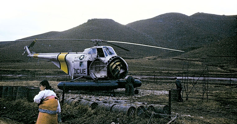 A Sikorsky H-19 rescue helicopter operates from a field landing zone on one of the guerrilla-held islands.