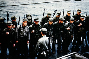 The SMG is assembled on the aft deck of the Wantuck for a final mission briefing on Iwon.