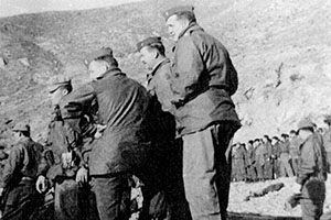 JACK paramilitary advisors (foreground) and the JACK guerrilla force lined up along the Yong-do shore watch the SMG paddle RB-10s out to the USS Wantuck, APD-125.