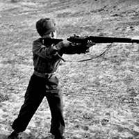 A young guerrilla with an M-1 Garand rifle