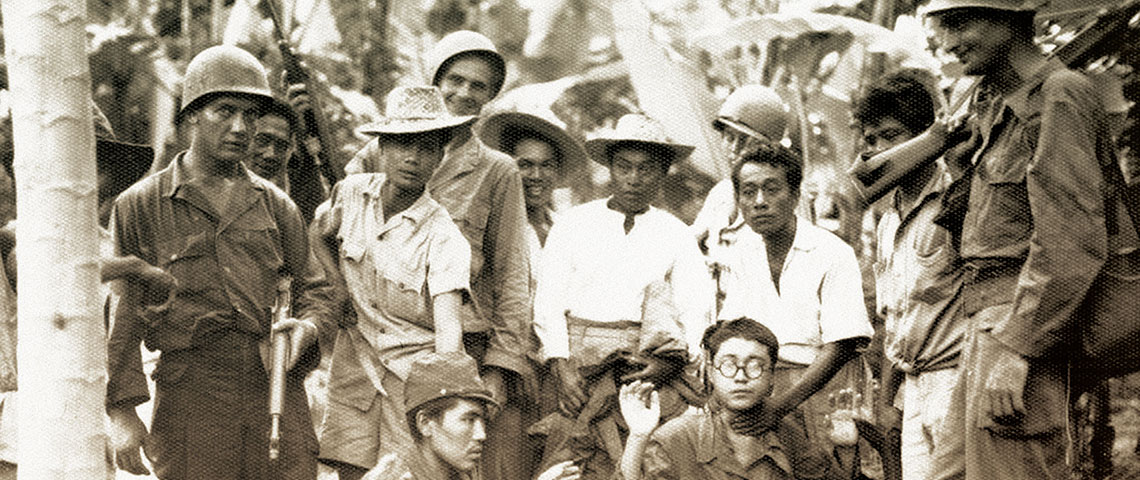 On Luzon Philippine guerrillas turn over two Japanese prisoners of war (POWs) to soldiers of the 25th Infantry Division