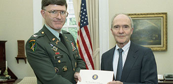 GEN (ret.) Brent Scowcroft, National Security Advisor to President George H.W. Bush, greets departing National Security Council staff member COL Jeffrey B. Jones in his office, 13 August 1992.