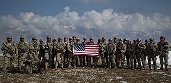 Sgt. Maj. Payne and his unit pose with the American flag while in Northern Iraq in 2017.