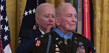 President Joseph Biden presents the Medal of Honor to retired Col. Ralph Puckett Jr. during a ceremony at the White House in Washington, D.C., May 21, 2021.