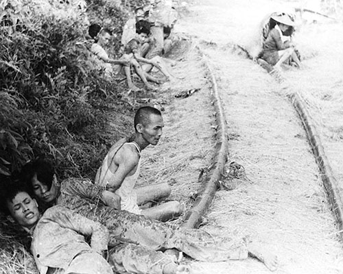 Suspected Chinese collaborators await interrogation by Team BUICK, China 1945.